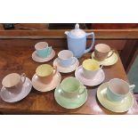 Branksome pottery part tea service in various colours comprising eight cups and saucers and a tea