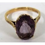 A 9ct gold amethyst cocktail ring with the faceted oval amethyst measuring approximately 12.6mm by