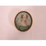 19th century ivory oval box, the lid with a painted portrait miniature of an attractive lady in