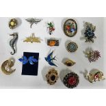 Sixteen brooches to include a Limoges, France, painted enamel, gilt, pearl and stone set, enamel