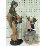 Two Nao figurines to include a lady standing together with a young girl, 39cm high, and another of a