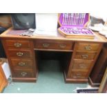 Mahogany pedestal desk, with central door, flanked by four graduating drawers on each side with