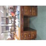 Oak desk with central door flanked by four graduating drawers, with green leather insert, 77cm x