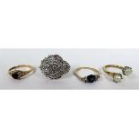 A marked 375 gold dress ring set with a dark red central stone, with faded markings, ring size O,