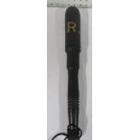 An antique police truncheon ornate shape with VR painted in large white letters, with blackened