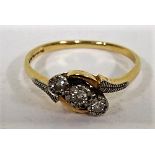 A marked 18ct gold triple diamond crossover ring, with maker's mark MWJ, with faded hallmarks,