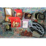 A small suitcase containing a collection of costume jewellery to include four coloured and painted
