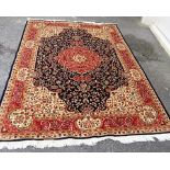 A new silk, wool and cotton rug with cream and red ground with a central navy medallion decorated