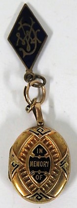 An unmarked gold (tested) Victorian memorial locket with engraved monogram to the front, with gilt