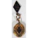 An unmarked gold (tested) Victorian memorial locket with engraved monogram to the front, with gilt