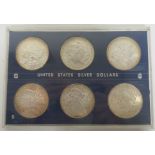 Cased set of six United States Silver Dolllars, dated for 1882 and another, 1885, 1887, 1888 and