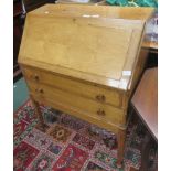 A pale oak writing bureau with fold down lid and two drawers below on four legs 100 x 77 x 44