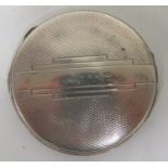 A hallmarked silver compact with mirror and grill of engine turned and geometric design,