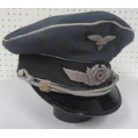 A Luftwaffe peaked cap with chincords, sliders, and leather sweat band. The leather sweat band is