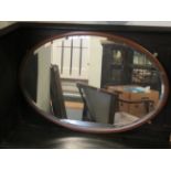 One oval Mahogany framed mirror