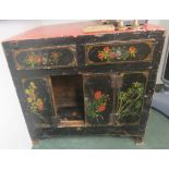 One square black painted cabinet with three drawers to front and with painted flowers, standing on