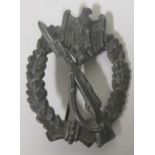 An Infantry assault badge, zinc flat back, with hinge and pin fitting, marked with a A W and