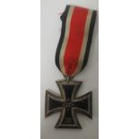 A World War II Second Class Iron Cross, complete with ribbon Condition: Some service wear and