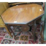 An octagonal occasional table on tapered bow legs and shelf below, inlaid top 68 x 72 x 72