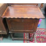 A small oak cabinet with wavey edge to lifting lid 70 x 62 x 46