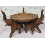 An oak floor stand supported by three elephants, 26cm high