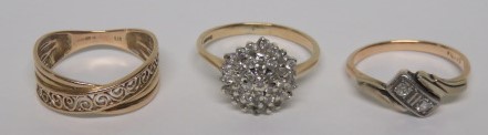 Two marked 375 gold and diamond dress rings, together with a marked 375 gold fancy cut band ring,