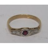 A circa 1940s marked 18ct and PT gold ring, set with a central ruby measuring approximately 2.5mm in
