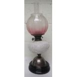 Victorian oil lamp with a white glass reservoir with repousse decoration, together with chimney
