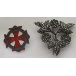 A marked silver and marcasite floral spray brooch measuring approximately 4.7cm in length,