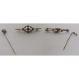 A rose gold/gilt stick pin star set with pink paste, together with a yellow metal stick pin set with
