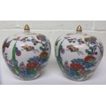 Pair of modern oriental jars with covers, hand painted with floral decoration