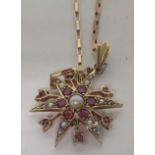 A marked 375 gold starburst pendant piece, set with rubies and seed pearls, the length (excluding