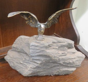 Brass eagle mounted on top of some stone
