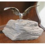 Brass eagle mounted on top of some stone