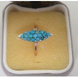 A marked 9ct gold rose gold ring, with a marquise shaped panel set with turquoise stones in