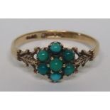 A marked 375 gold turquoise stone flower ring, set with openwork leaf design shoulders, the