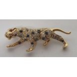 A 14ct gold diamond and sapphire leopard brooch, measuring approximately 38mm in length with a