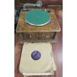 An unnamed oak wind up gramophone, with a collection of nine records