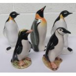 Five ceramic penguins, to include two made by Poole pottery