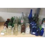 Quantity of coloured and clear glass bottles