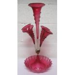 A Victorian cranberry glass five fluted epergne, a central flute surrounded by four smaller ones