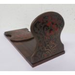 An oak sliding book ends, with each hinged end with decorative brass and red tortoiseshell design,