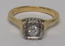 A marked 18ct gold and Plat solitaire diamond ring, the round cut diamond measuring approximately