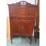 Edwardian inlaid mahogany music cabinet with four drawers above two cupboard doors, with the doors