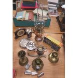 Quantity of general miscellanea to include lighters, a mantel clock, silver plate, oil lamp bases