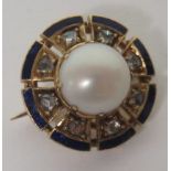 An unmarked gold (tested) small circular brooch, set with eight old cut diamonds with a blue