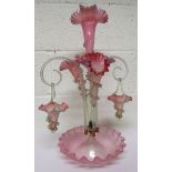 A Victorian light cranberry and light blue glass three flute epergne, a central flute surrounded