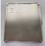 Silver cigarette case with engine turned design and the initials M.C engraved to the top right,