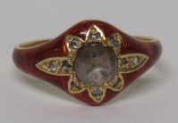 A gold diamond and red guilloche enamel ring, set with a central old rose cut diamond measuring