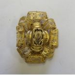 A Victorian unmarked yellow metal finely worked filigree brooch, the surface testing indicating as